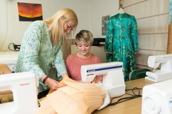 Latora Lezotte '20, a 剧院 degree major, and Prof. Kim Instenes work on a costume for a theatr...